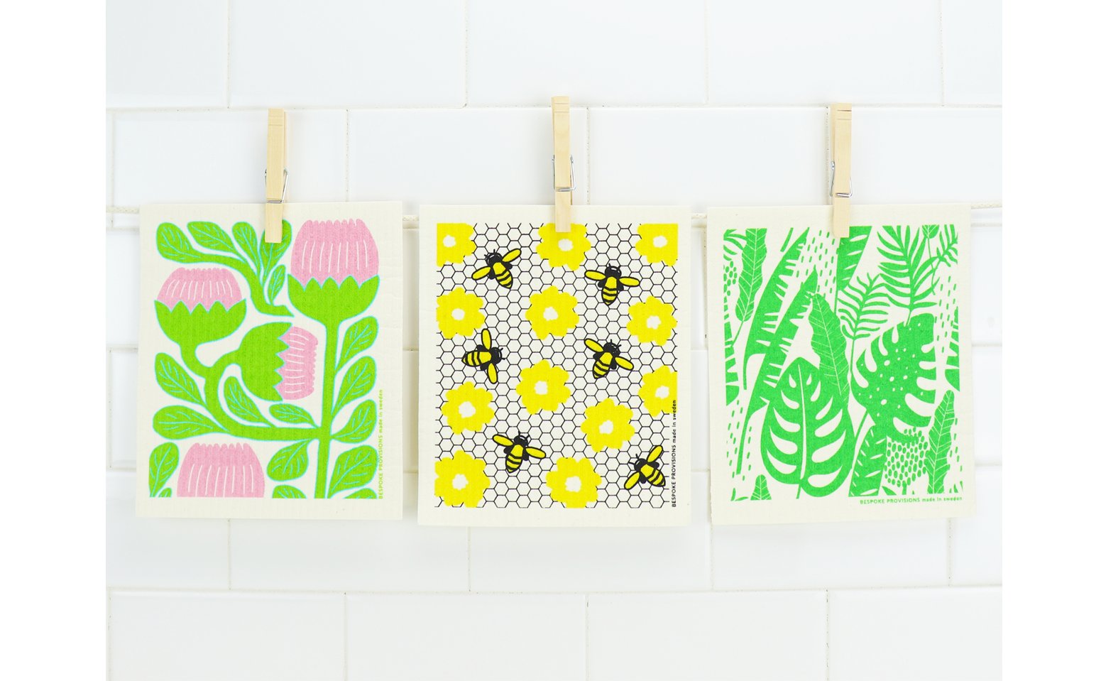 Swedish dishcloths hanging by clothespins.